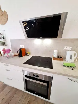 a kitchen with a stove top oven in a counter at Grand studio dans le centre historique in Aix-en-Provence