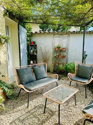 two chairs and a table on a patio at Havre de paix proche centre ville, jardin, piscine in LʼIsle-sur-la-Sorgue