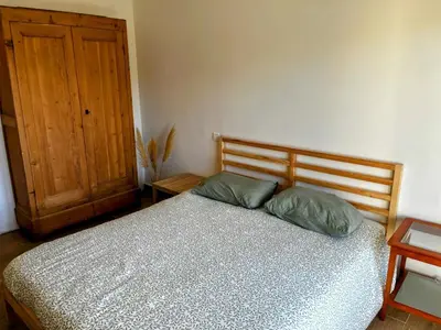 a bedroom with a bed with two pillows and a door at Villa Papillon in Monteux