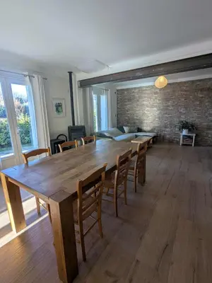 a dining room with a large wooden table and chairs at Villa Papillon in Monteux