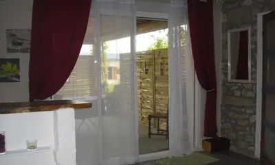 a room with a window with red curtains at Lou mas li Pitchoun 