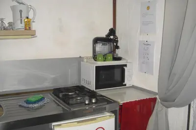 a microwave sitting on top of a stove in a kitchen at Lou mas li Pitchoun 