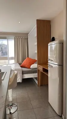 a small bedroom with a bed and a refrigerator at Slux Studio 399 in Aix-en-Provence