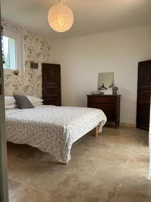 a bedroom with a bed and a dresser in it at Mas des Côtes in Saint-Hippolyte-le-Graveyron