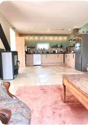a large room with a large kitchen with appliances at Mas des Côtes in Saint-Hippolyte-le-Graveyron
