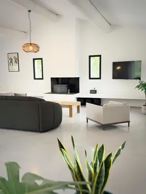 a living room with a couch and a table at La Villa des Glauges in Eyguières