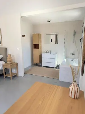 a room with a bathroom with a tub and a sink at La Villa des Glauges in Eyguières