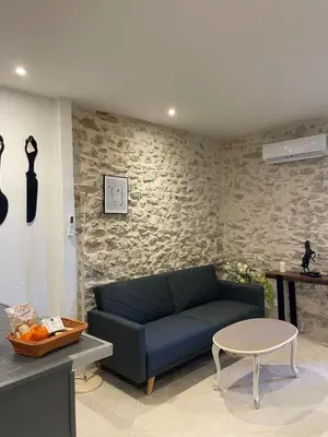 a living room with a blue couch and a table at Apartment in L'Isle-sur-la-Sorgue with parking in LʼIsle-sur-la-Sorgue