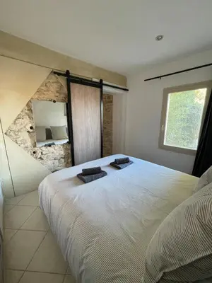 a bedroom with a large white bed with a window at Apartment in L'Isle-sur-la-Sorgue with parking in LʼIsle-sur-la-Sorgue