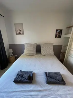 a bedroom with a bed with two towels on it at Apartment in L'Isle-sur-la-Sorgue with parking in LʼIsle-sur-la-Sorgue