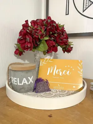 a vase with flowers and a box on a table at La Bastide du Golfeur, Jardin et Piscine in Mallemort