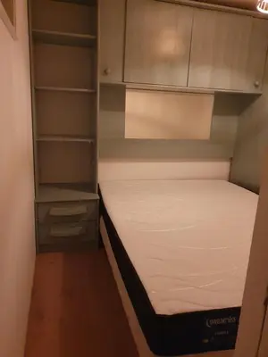 a small bedroom with a bed and cabinets at Chalet en provence