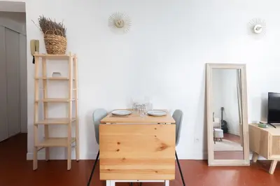 a room with a wooden dresser and a mirror at Modern studio Le Renoir - Center of city - WiFi in Aix-en-Provence
