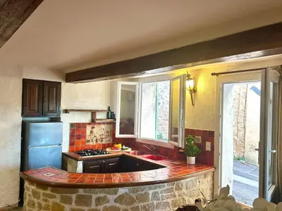 a kitchen with a sink and a stove top oven at Charmante maison de village avec clim et parking à proximité d'Aix-en-Provence in Éguilles