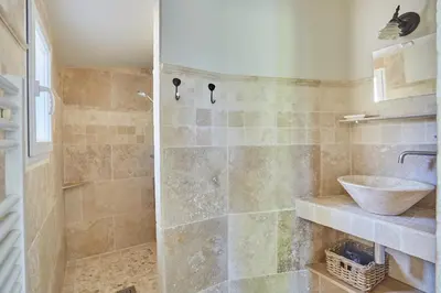 a bathroom with a sink and a shower at La Paulanne in Bonnieux