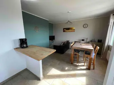 a kitchen and dining room with a table and chairs at Le gîte des granges in Bédoin