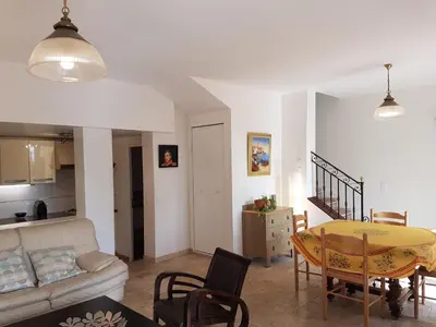 a living room with a table and a couch at Holiday House Teulon in Éguilles