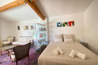 a bedroom with a large bed with two pillows on it at Family villa with garden and pool in LʼIsle-sur-la-Sorgue