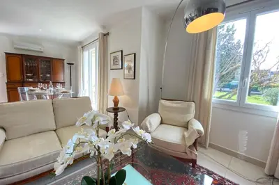 a living room with a couch and a table at Family villa with garden and pool in LʼIsle-sur-la-Sorgue