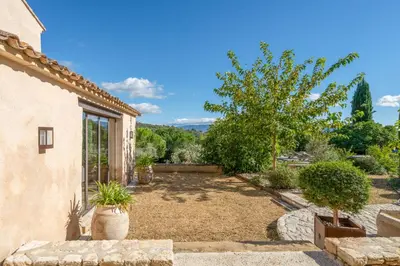 a garden with a large yard with trees at Bastide de Guby in Saint-Saturnin-les-Apt