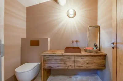a bathroom with a toilet and a sink and a mirror at Bastide de Guby in Saint-Saturnin-les-Apt