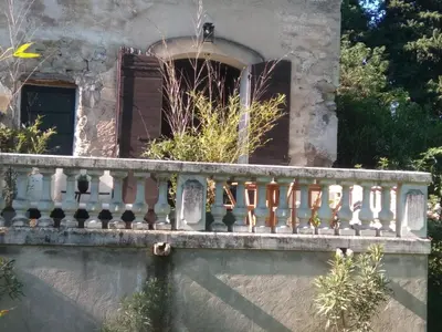 a balcony of a house with a window at Les feuillets de la Buire in Monteux
