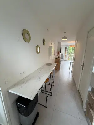 a kitchen with a white counter and a table at Appartement moderne 3 chambres avec parking sécurisée in Aix-en-Provence