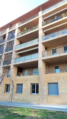 a wooden table and chairs on a balcony with a view at Calme T2, Wifi, Proche centre et sites culturels, Vue magnifique in Aix-en-Provence