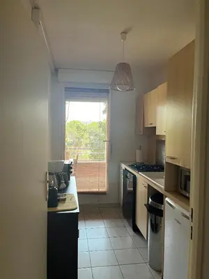 a kitchen with a counter and a window in it at Calme T2, Wifi, Proche centre et sites culturels, Vue magnifique in Aix-en-Provence