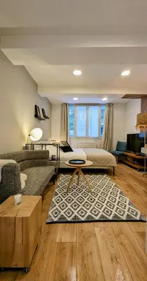 a living room with a couch and a table at Appartement Aix centre ville in Aix-en-Provence