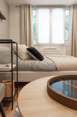 a living room with a bed and a glass table at Appartement Aix centre ville in Aix-en-Provence