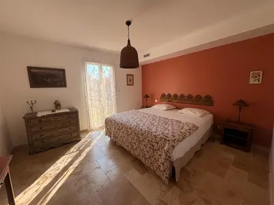 a bedroom with a large bed and a window at Farniente à Valloncourt in Cheval-Blanc