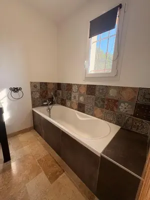 a bath tub in a bathroom with a window at Farniente à Valloncourt in Cheval-Blanc