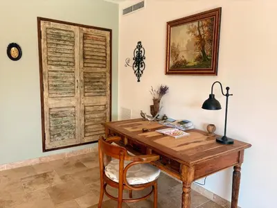 a wooden desk in a room with a window at Farniente à Valloncourt in Cheval-Blanc