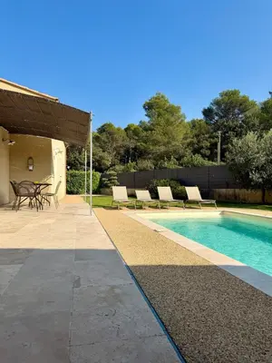 a swimming pool with chairs and a table next to a house at Farniente à Valloncourt in Cheval-Blanc