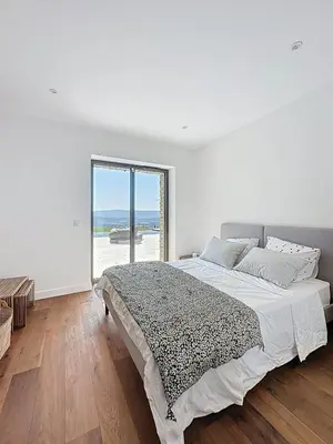 a white bedroom with a bed and a large window at 180 Grand Luberon Gordes vue panoramique in Gordes