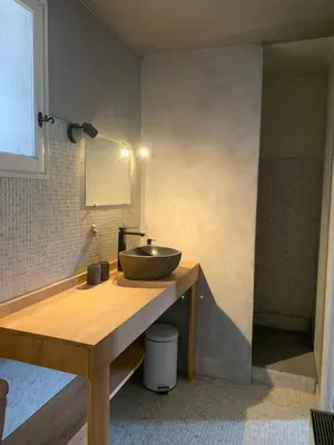 a bathroom with a sink on a wooden counter at La Commanderie du Ventoux in Mormoiron