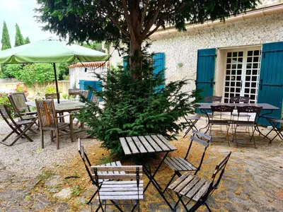 a group of tables and chairs with a christmas tree at La Commanderie du Ventoux in Mormoiron
