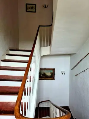 a staircase in a building with a stair case at La Commanderie du Ventoux in Mormoiron