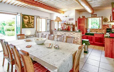 a kitchen with a large table with chairs around it at Maison Avec Piscine Privée in Villars