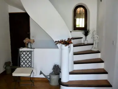a staircase in a home with a white stair case at Holiday Home Charmantes Landhaus mit Garten by Interhome in Pierrevert