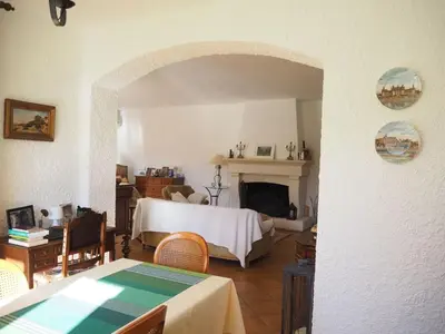 a living room with a bed and a fireplace at Holiday Home Charmantes Landhaus mit Garten by Interhome in Pierrevert