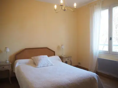 a bedroom with a bed and a window at Holiday Home Charmantes Landhaus mit Garten by Interhome in Pierrevert