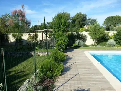 a garden with a fence and a swimming pool at Holiday Home Die Gîtes de Bel-Air im Luberon in der Provence by Interhome in Les Taillades