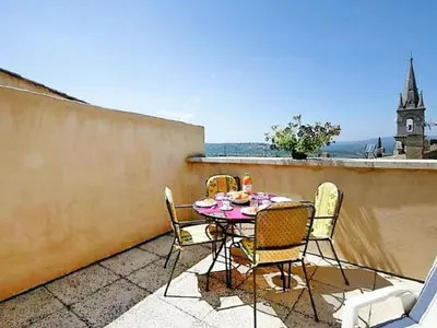 a table and chairs sitting on a balcony at Apartment Morard - Bonnieux Appt Les Ocres by Interhome in Bonnieux
