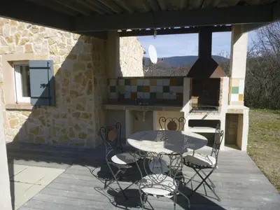 a patio with a table and chairs and a grill at Holiday Home Provenzalisches Ferienhaus mit Charme auf dem Land mit Pool by Interhome in Villars