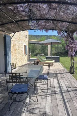 a patio with a table and chairs and an umbrella at Holiday Home Provenzalisches Ferienhaus mit Charme auf dem Land mit Pool by Interhome in Villars