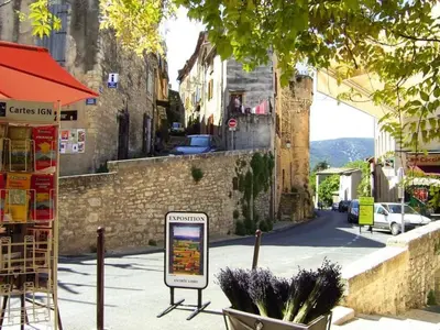 a city street with a sign on the sidewalk at Apartment Morard - Bonnieux Appt 2- Etage by Interhome in Bonnieux