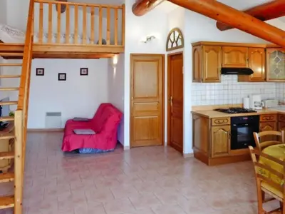 a kitchen with a red chair in a room at Apartment Morard - Bonnieux Appt 2- Etage by Interhome in Bonnieux