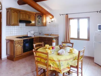 a kitchen with a table with a yellow table cloth at Apartment Morard - Bonnieux Appt 2- Etage by Interhome in Bonnieux